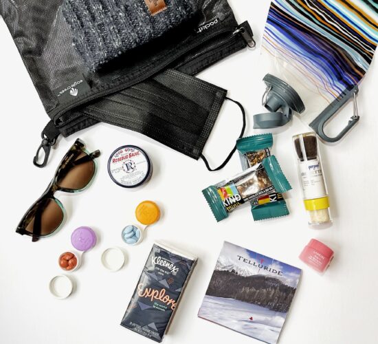 pouch holding ski supplies like granola bars, kleenex, laneige, trail map and sunglasses