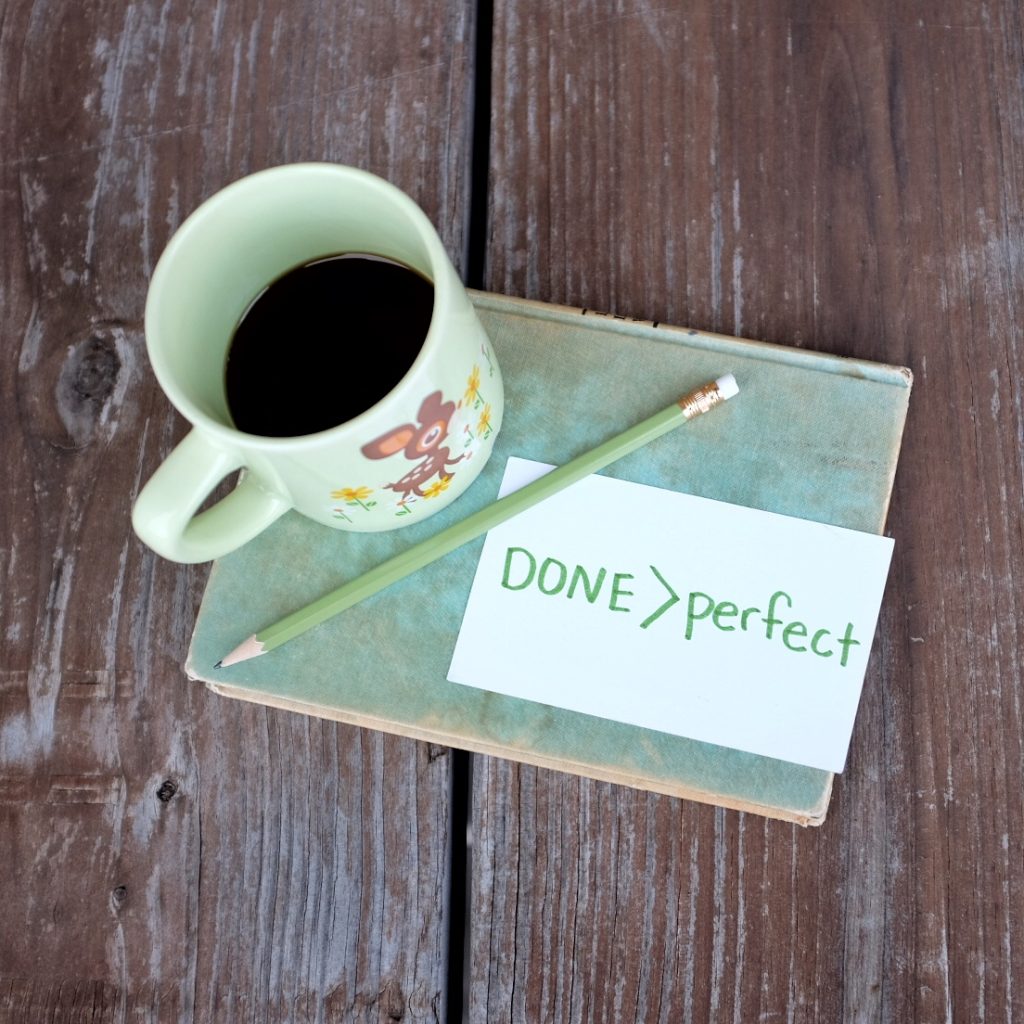 coffee cup and done is better than perfect message on a notecard