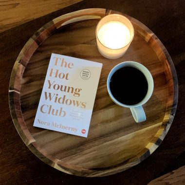 copy of hot young widows club book with a candle and a coffee sitting on a tray