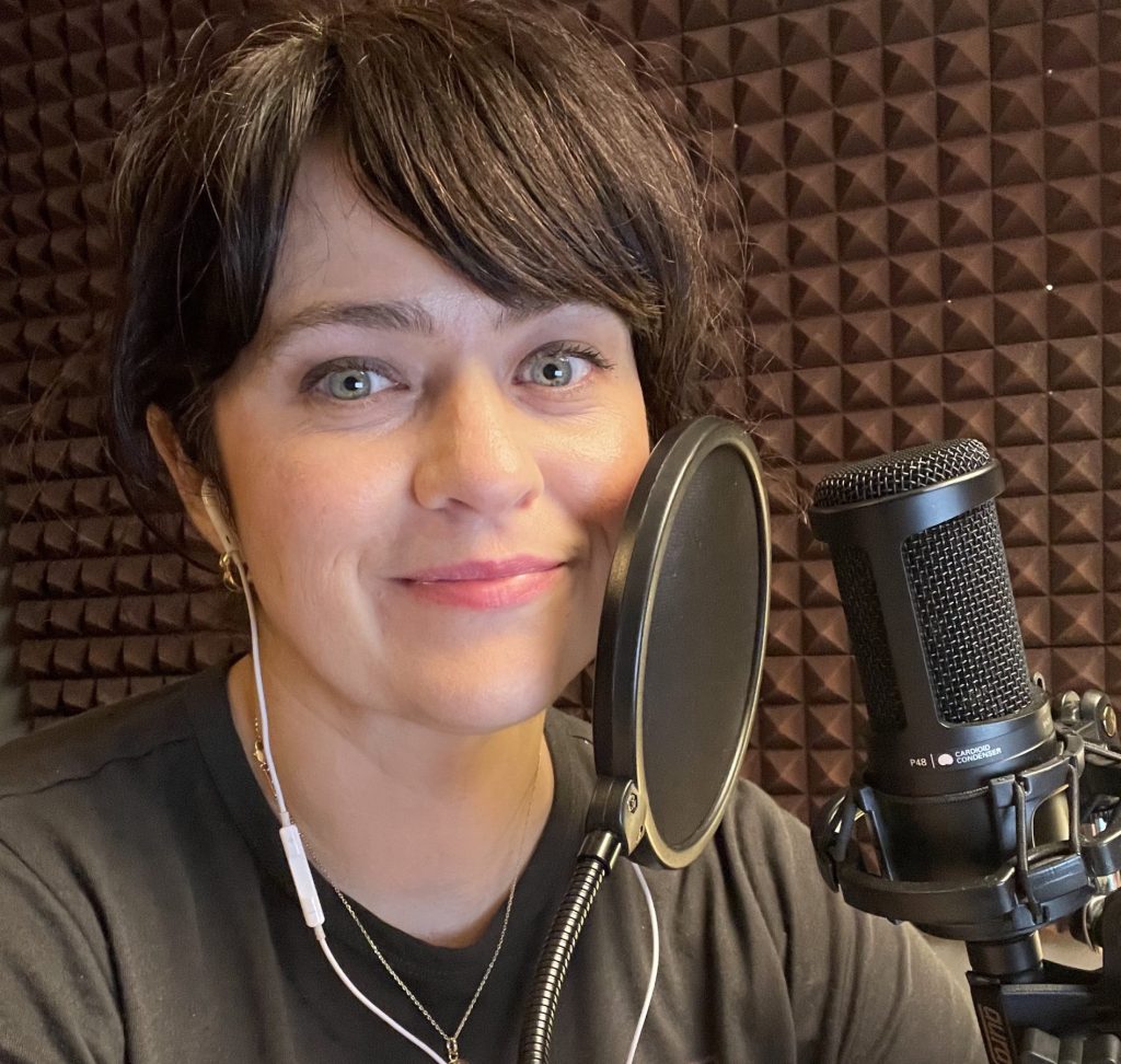 carrie rollwagen records a podcast in the studio