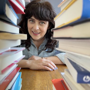 carrie rollwagen between two stacks of books
