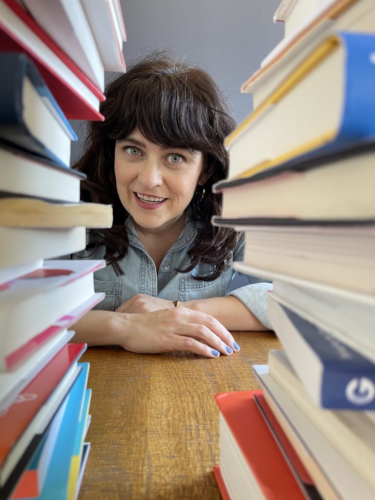 carrie rollwagen between two stacks of books