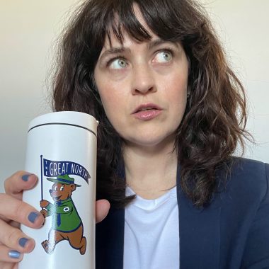 carrie looking vaguely annoyed holding coffee mug