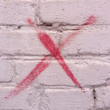x painted on a brick wall